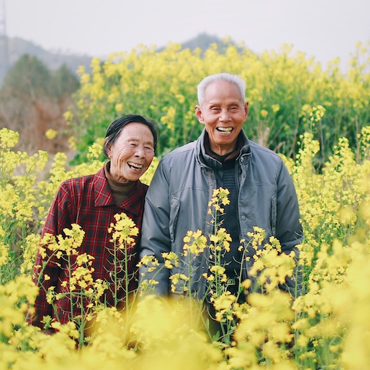 Stylish elder doing tai chi on a mountaintop